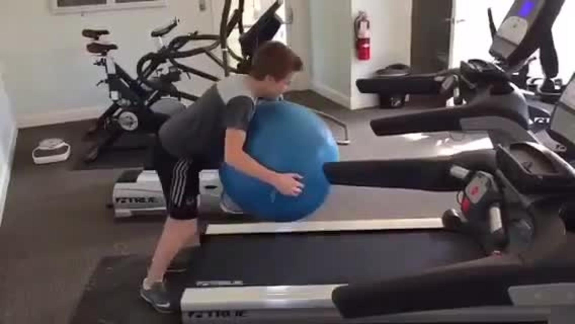 Teen Faceplants Bouncing Exercise Ball on Treadmill Jukin Media Inc