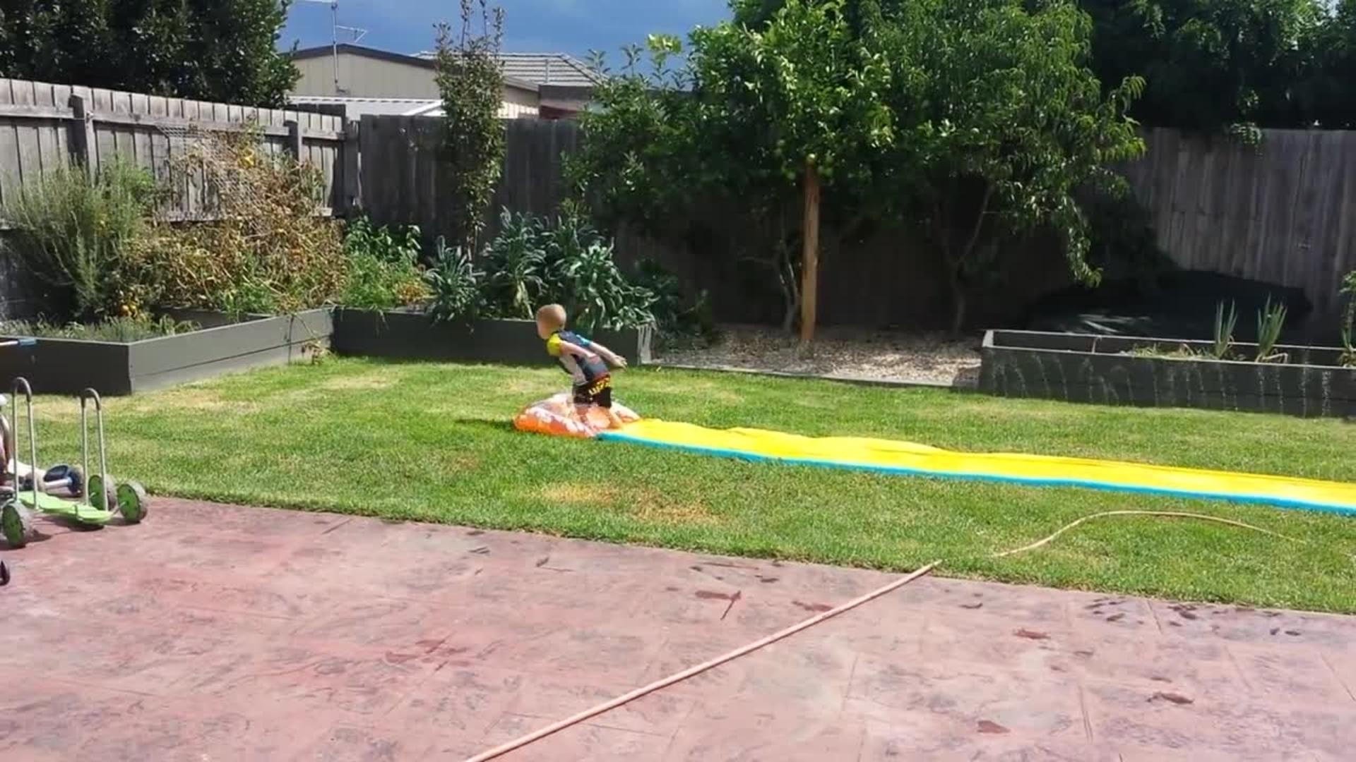 Guy Flies off Rooftop SlipnSlide and Flies Over Inflatable Pool