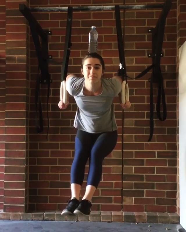 Girl Balances Water Bottle on Head while on Rings Jukin Licensing