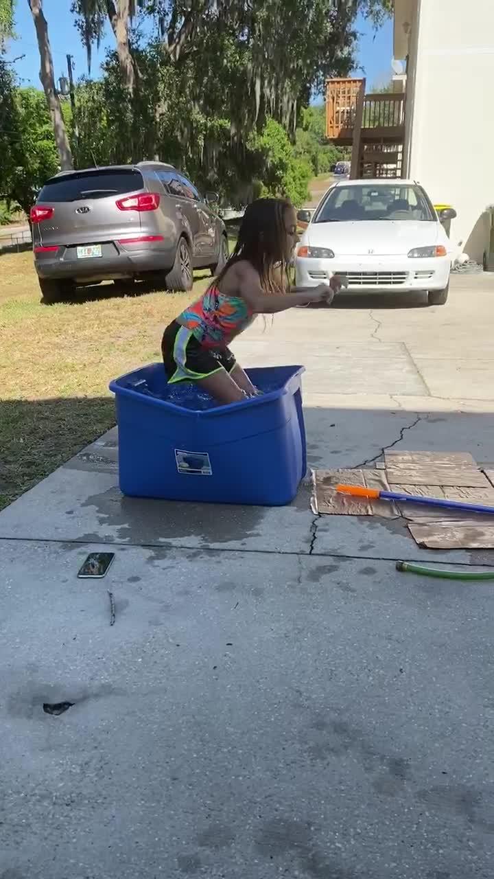 Girl Falls Flat on Face While Jumping Out of WaterFilled Plastic Tote