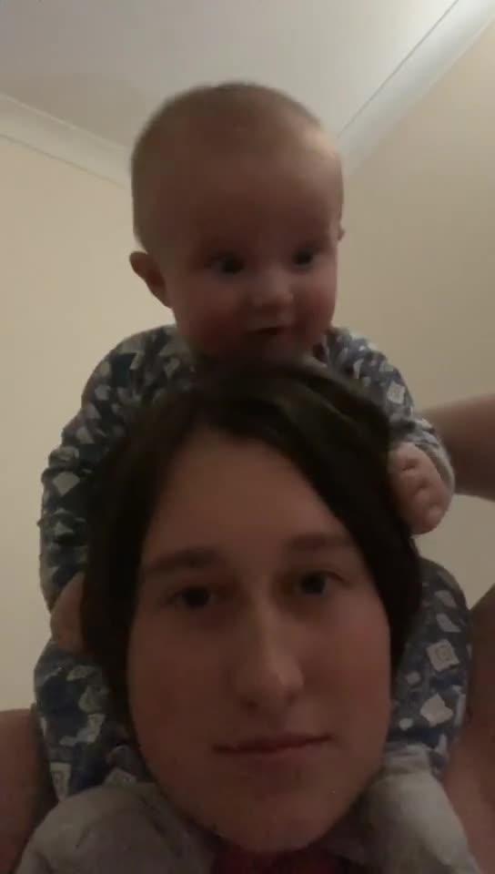 baby-pukes-on-mom-s-head-while-sitting-on-her-shoulders-jukin-licensing