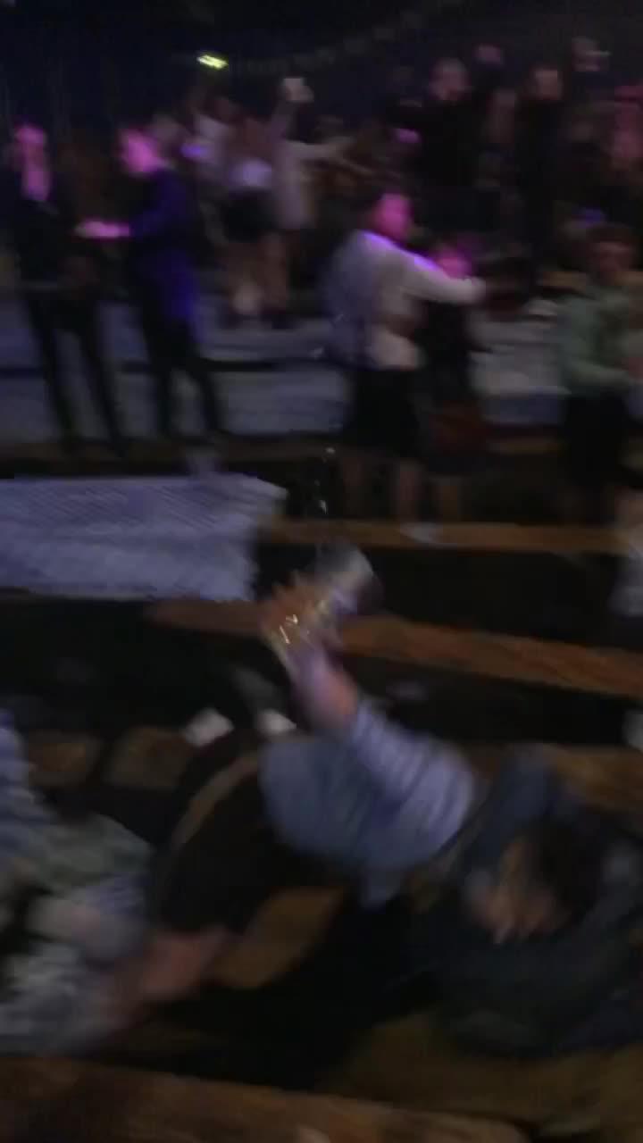 Two Girls Fall While Dancing on Table as Guy Kicks and Break it