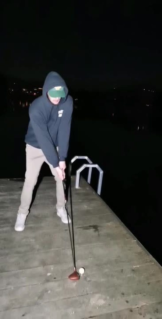 Guy Loses Golf Club in Lake While Hitting Golf Balls off Dock into