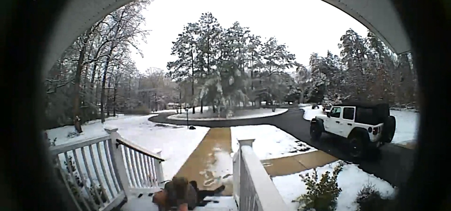 Lady Slips on Ice While Walking Downstairs on Porch During Snowstorm Jukin Licensing