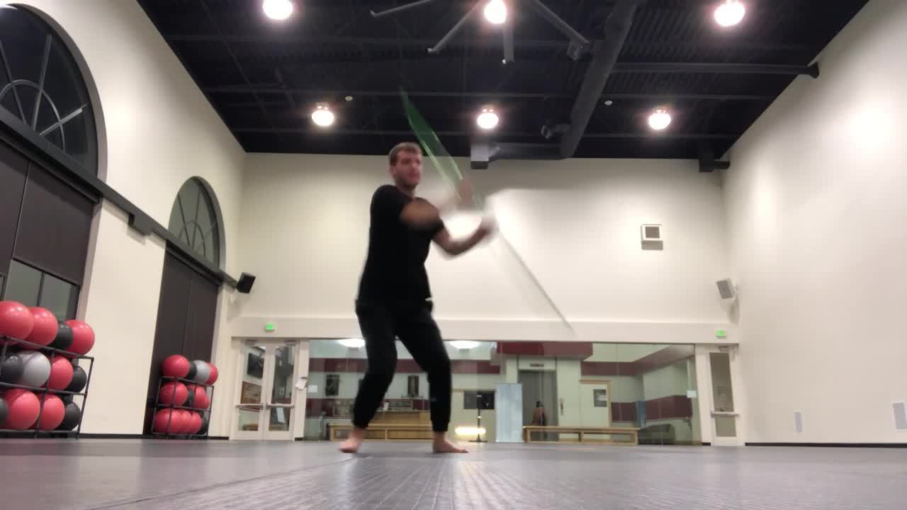 Man Shows Impressive And Fast Moves Using a Bo Staff While Practicing