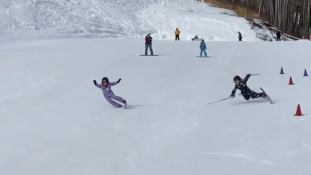 Two Kids Skiing Downhill Have a Synchronized Fall Jukin Licensing
