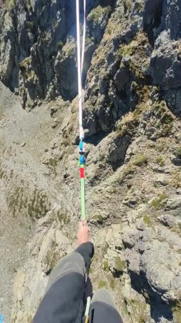 Man Walks on Slackline Between Two Mountains Jukin Licensing