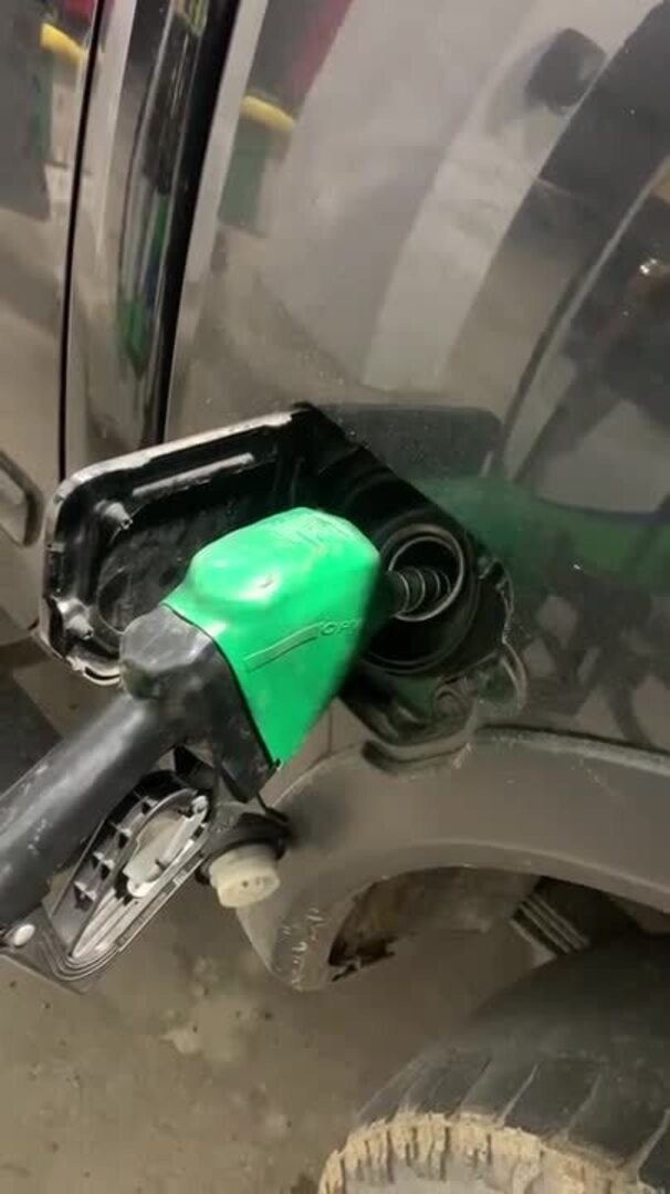 Gas Pump Malfunctions and Overflows as Person Tries to Pump Gas in Car